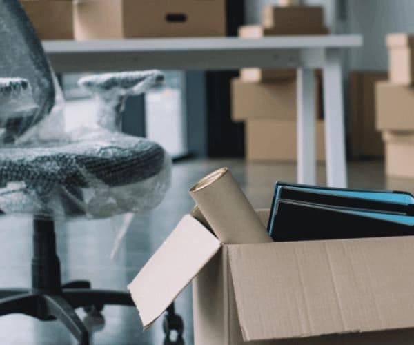 Office chair and files packed for an office relocation
